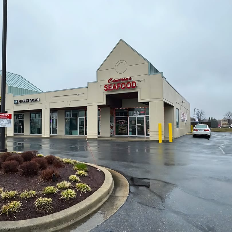 Exterior of Cameron's Seafood restaurant on a cloudy day, with a white car in the parking lot.