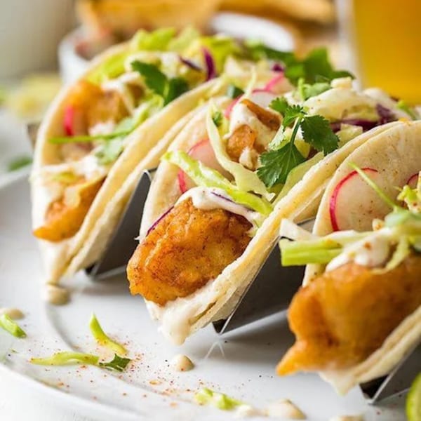 Three Cameron's Seafood fish tacos with crispy fried fish, cabbage, radish, and cilantro.